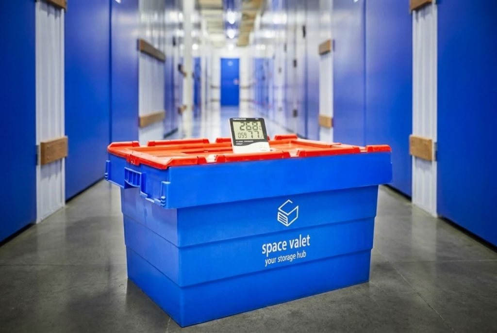 Blue storage container in warehouse corridor used for organized industrial storage.